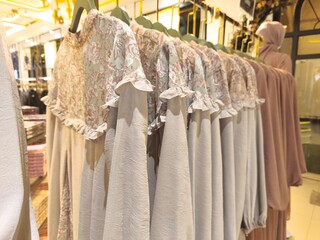 A collection of Muslim clothing for women with various designs, patterns and colors is sold in a clothing shop.