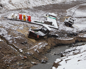 Old ships on the banks of a dried-up river. The effects of global warming on river navigation
