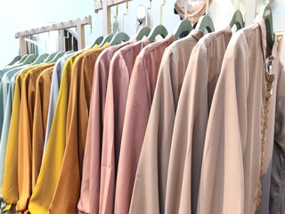 A collection of Muslim clothing for women with various designs, patterns and colors is sold in a clothing shop.
