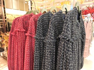 A collection of Muslim clothing for women with various designs, patterns and colors is sold in a clothing shop.