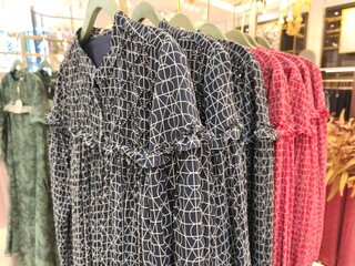 A collection of Muslim clothing for women with various designs, patterns and colors is sold in a clothing shop.