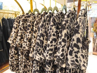 A collection of Muslim clothing for women with various designs, patterns and colors is sold in a clothing shop.