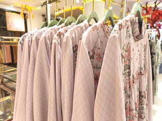 A collection of Muslim clothing for women with various designs, patterns and colors is sold in a clothing shop.