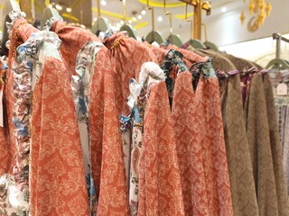 A collection of Muslim clothing for women with various designs, patterns and colors is sold in a clothing shop.