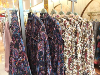 A collection of Muslim clothing for women with various designs, patterns and colors is sold in a clothing shop.