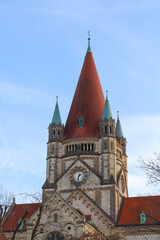 Fototapeta premium An ancient Christian church with a red roof. An ancient church with towers