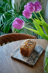Pumpkin sweet bread with pumpkin seeds and walnuts. Wooden background, top view.