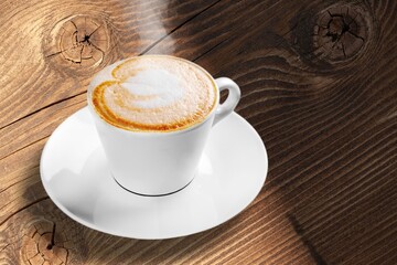 Coffee cup and beans on cafe background