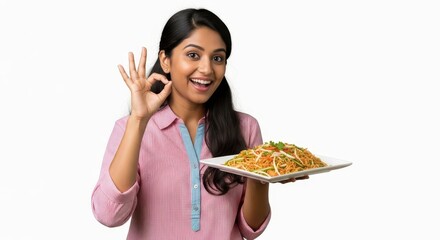 Woman holding a plate of noodles and making an ok gesture with her hand on a white background