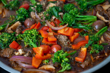 Close up of Healthy One Pot Meal of Ground Bison, Mushrooms, Broccoli, Barley, and Quinoa with Fresh Herbs