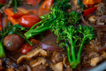 Close up of Healthy One Pot Meal of Ground Bison, Mushrooms, Broccoli, Barley, and Quinoa with Fresh Herbs