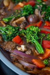 Close up of Healthy One Pot Meal of Ground Bison, Mushrooms, Broccoli, Barley, and Quinoa with Fresh Herbs