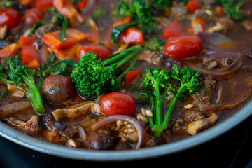 Close up of Healthy One Pot Meal of Ground Bison, Mushrooms, Broccoli, Barley, and Quinoa with Fresh Herbs