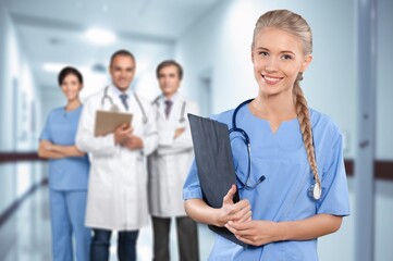 Confident happy nurse with healthcare team in hospital