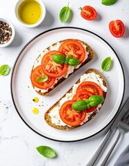 Top-down view of whole grain toast with ricotta, sliced tomatoes, olive oil, black pepper, basil garnish on white plate over marble. Bright, fresh, clean breakfast scene.