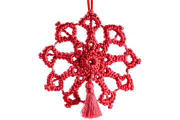 Handmade red crochet snowflake ornament with tassel against a dark transparent background