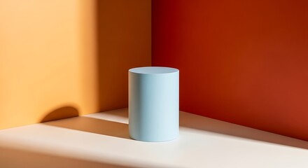 Minimalist Still Life Blue Cylinder Object on White Platform Against Geometric Orange and Yellow Background