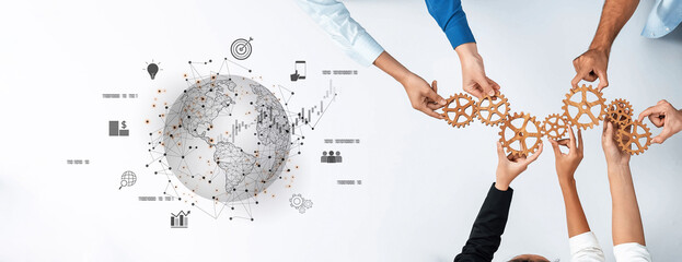 Hands of diverse individuals hold gears above a graphical globe, symbolizing teamwork and innovation in a connected digital world, ideal for business and strategy themes. Trope