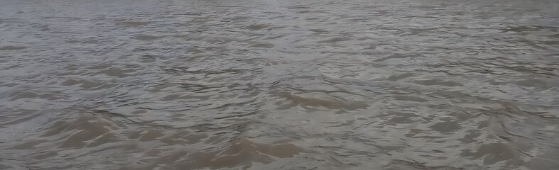 Calm Water Surface Reflecting Overcast Sky Ideal for Background Use