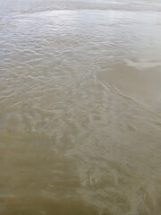 Murky Water Surface Reflecting Ambient Light creating Textural Patterns
