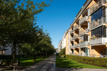 Pedestrian walkway with residential buildings in Hammarby Sjostad Stockholm, Scandinavian sustainable living design combining greenery, urban planning and contemporary architecture