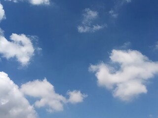 Beautiful blue sky with fluffy white clouds background summertime landscape