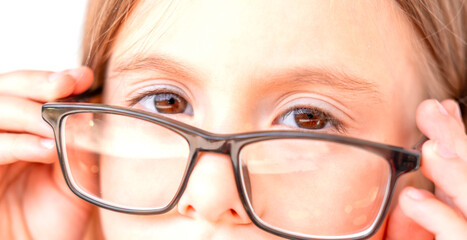 Little girl with medical eyeglasses, diopter lenses, eye test, preschool child with vision problem, prescription glasses, corrective eyewear close-up, childhood health, healthy vision