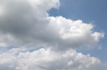 Fluffy white clouds in a bright blue sky during daytime