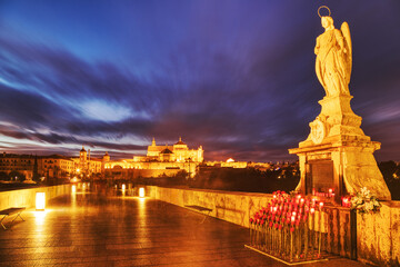 Illuminated Mezquita Cathedral and Roman Bridge in Cordoba at Sunset, Andalusia