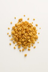 Crunchy toasted rice cereal with almonds scattered on a plain white background isolated