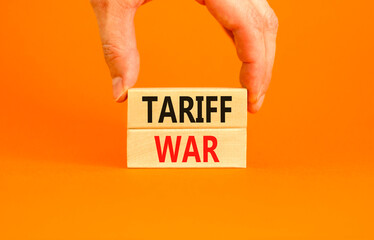 Trade tariff war symbol. Concept word Tariff war on beautiful wooden blocks. Beautiful orange paper...
