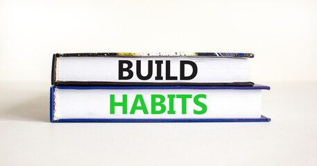 Build habits symbol. Concept word Build habits on beautiful books. Beautiful white paper background. Business build habits concept. Copy space.