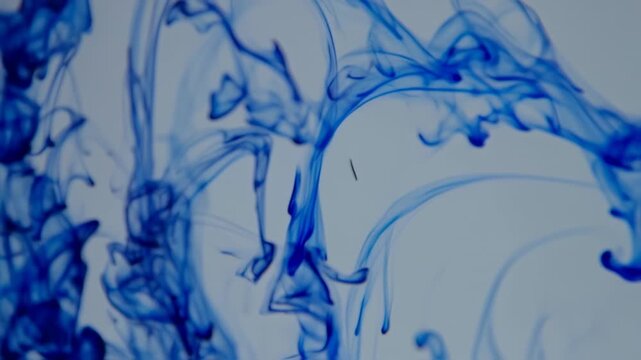 Abstract blue ink swirling in liquid