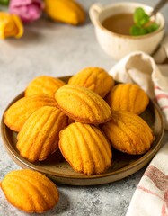 Stacked golden-yellow cookies on a plate