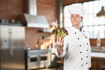 Happy young male chef wear uniform posing