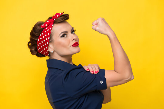 Rosie the Riveter&ndash;style empowerment image with flexed pose, red polka-dot headband, navy shirt, and bright yellow background &mdash; celebrating strength and resilience. generative ai