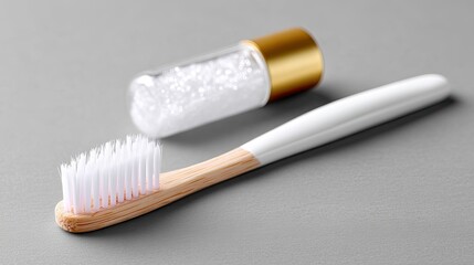 Dental Care Still Life Featuring White Toothbrush with Tan Handle and Small Vial of White Powder on Gray Background