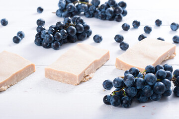 handmade soaps from red grapes seed oil, on white wood table