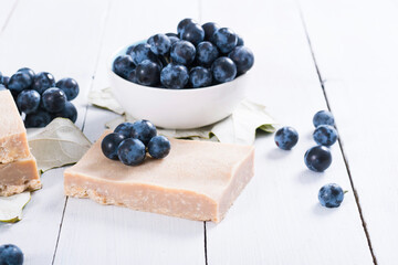 handmade soaps from red grapes seed oil, on white wood table