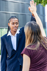 multicultural Business partners giving high five celebrating success in the financial district