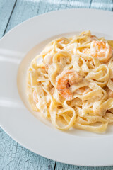 Creamy fettuccine shrimp pasta white plate savory sauce gourmet flavor
