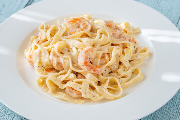 Creamy fettuccine shrimp pasta white plate savory sauce gourmet flavor