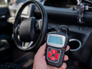 Woman using OBD2 diagnostic scanner. 