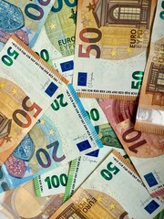 Assorted euro banknotes spread on marble