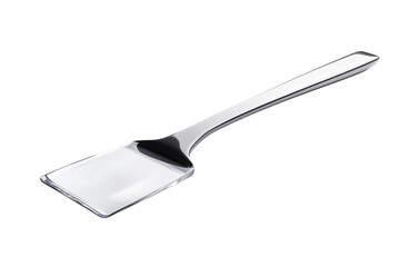 Shiny silver metal cake server isolated against a dramatic transparent background for editorial use