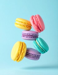 Colorful macarons float mid-air on pastel blue background. Pink, yellow, purple, and turquoise cookies in soft light. Minimal, playful, elegant dessert display.