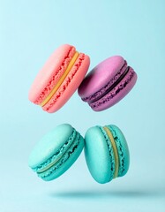Colorful macarons float mid-air on pastel blue background. Pink, yellow, purple, and turquoise cookies in soft light. Minimal, playful, elegant dessert display.
