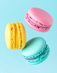 Colorful macarons float mid-air on pastel blue background. Pink, yellow, purple, and turquoise cookies in soft light. Minimal, playful, elegant dessert display.