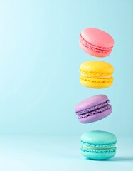 Colorful macarons float mid-air on pastel blue background. Pink, yellow, purple, and turquoise cookies in soft light. Minimal, playful, elegant dessert display.