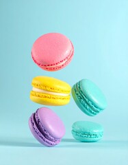 Colorful macarons float mid-air on pastel blue background. Pink, yellow, purple, and turquoise cookies in soft light. Minimal, playful, elegant dessert display.